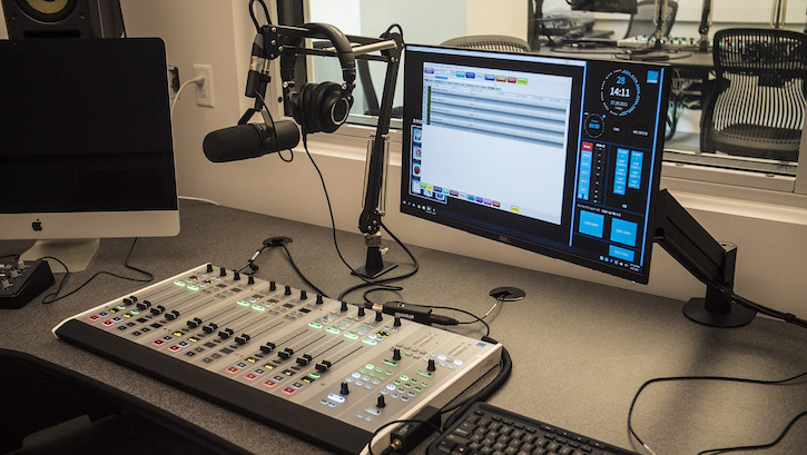 Studio equipment for radio with microphone, computer, and sound board