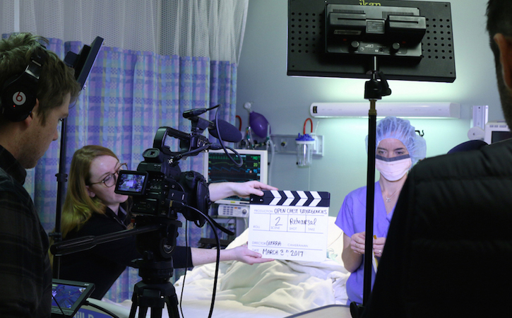 students and Professor Oscar Guerra shooting video in an operating room